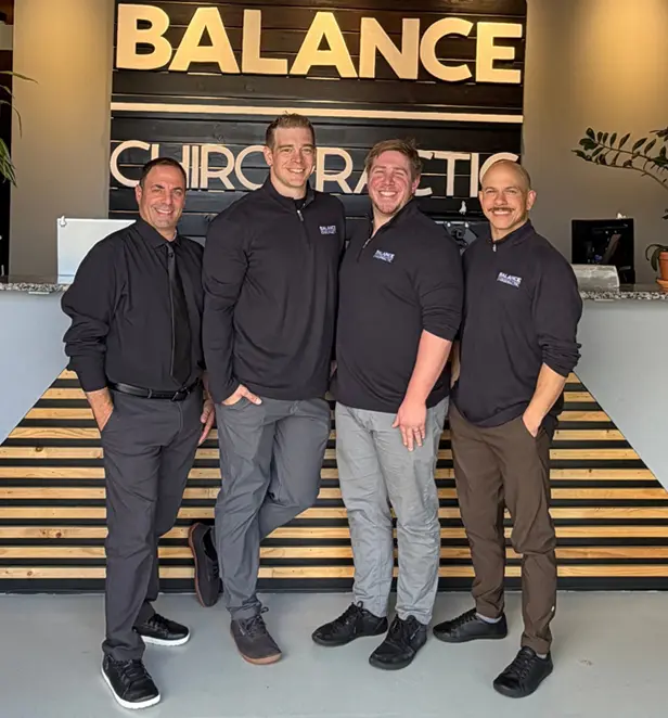 David Liberman, Max Pohl, Matthew Hurtado, and Ernesto Fernandez standing together at Balance Chiropractic in Colorado Springs, Colorado