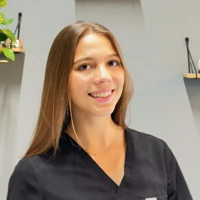 Payden Coffey smiling at the camera while wearing a black top